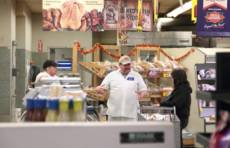 A shopper talks with Johnnie's Foodmaster employees during the final week and a half of the supermarket's existence.November 9, 2012.