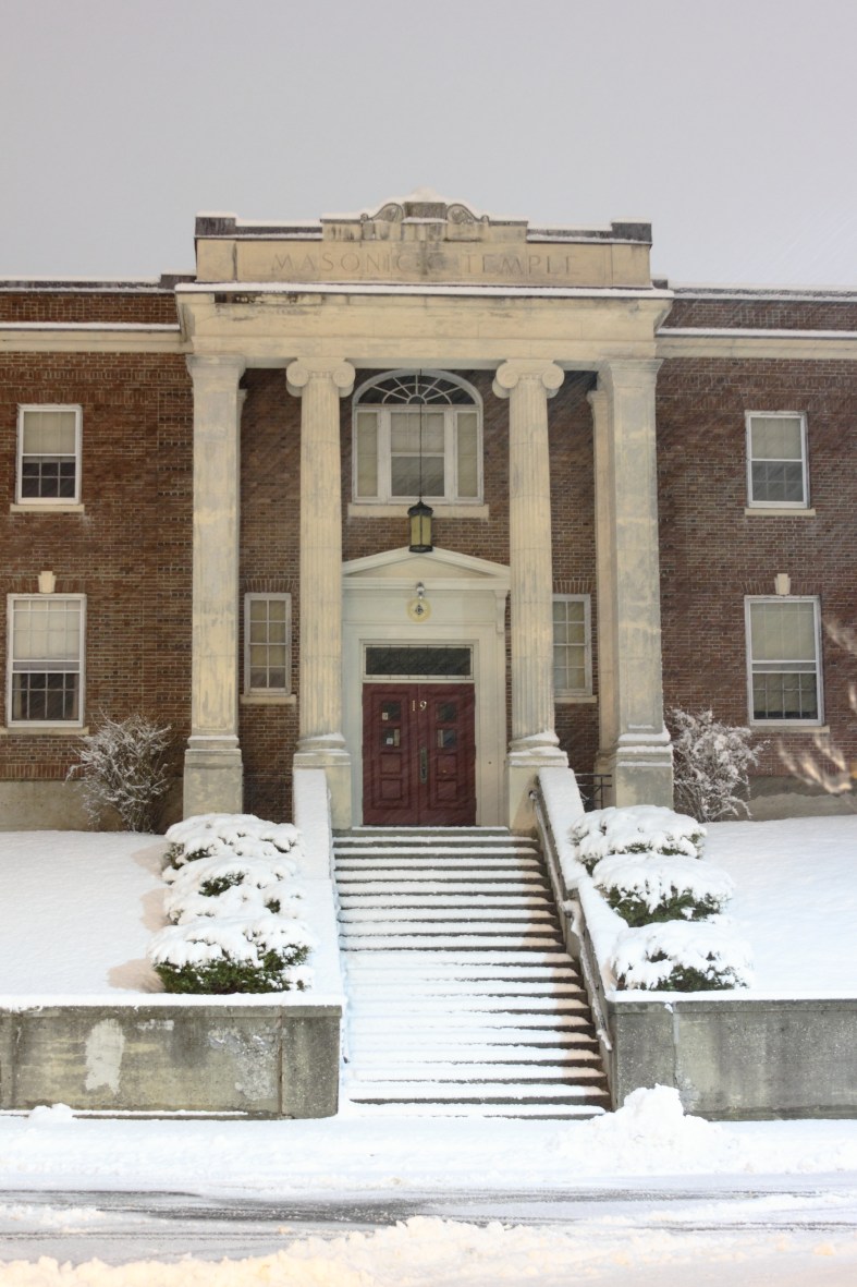 Snow collects quickly on the Masonic Temple on Academy Street.December 29, 2012.