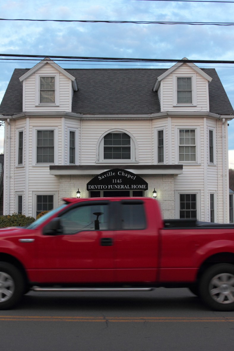 A red truck passes in front of DeVito Funeral Home on Massachusetts Avenue.January 14, 2013.