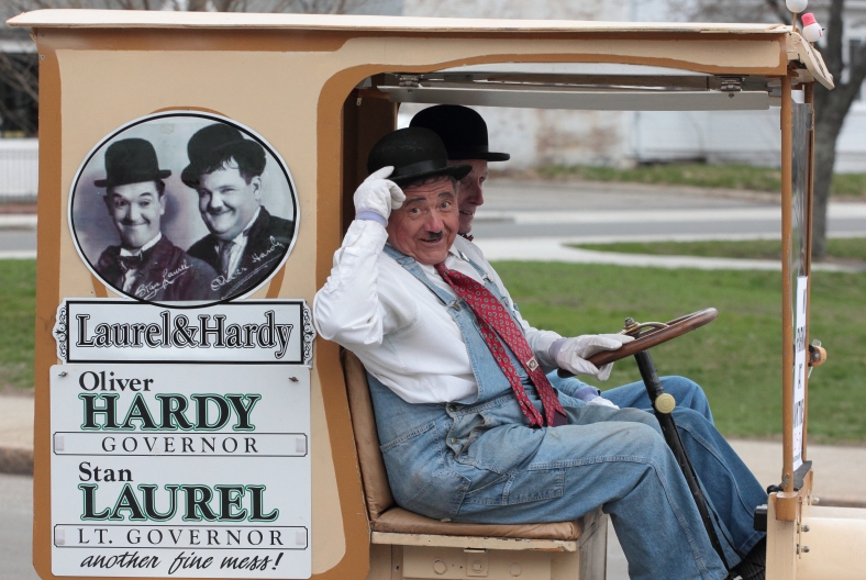 Shriners dressed as Stan Laurel and Oliver Hardy drive down Massachusetts Avenue during the Patriots' Day parade. April 14, 2013.