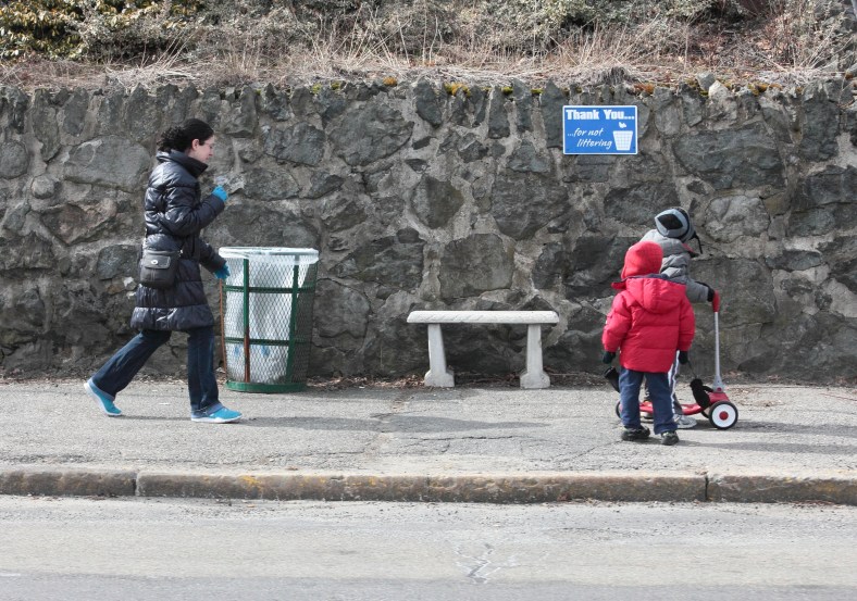 A mom keeps close behind her kids as they walk (and scoot) down Massachusetts Avenue. March 16, 2013.