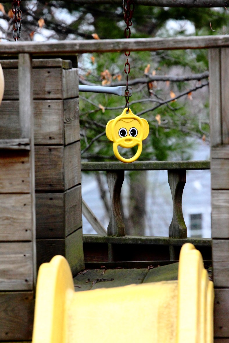 A smiling monkey face on a play set in the yard of a Ravine Street home. April 14, 2013.