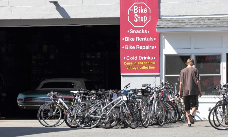 A teen enters the Bike Stop through the Dudley Street entrance. July 25, 2012.