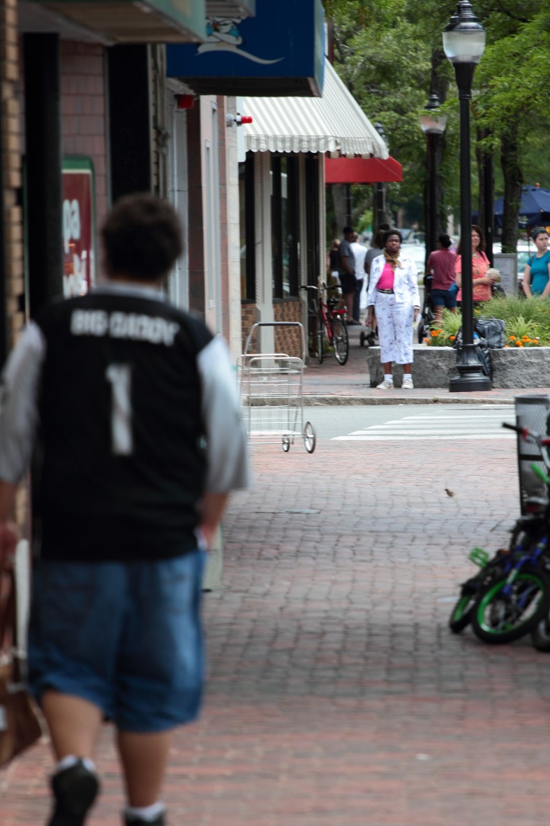 A woman waits for a crosswalk in Arlington Center. May 28, 2012.
