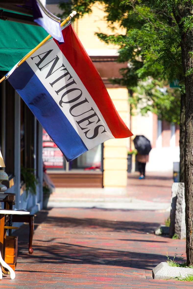A flag advertising antiques outside the Lena Nargozian Gallery on Massachusetts Avenue. July 5, 2013.
