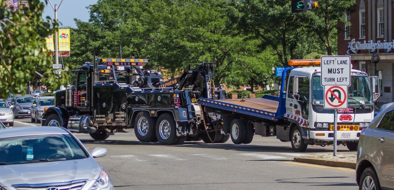 A tow truck tows a tow truck through Arlington Center. July 5, 2013.