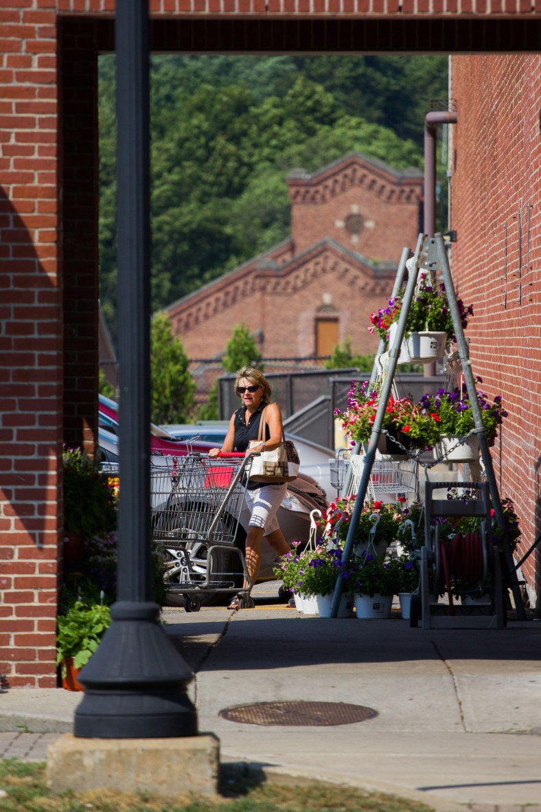 A woman pushes a cart into Stop and Shop, getting out of the 97˚ heat. July 19, 2013.