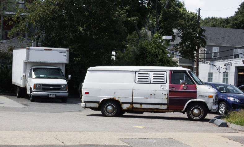 A old van with window louvers parked at a Massachusetts Avenue filling station. August 14, 2013.