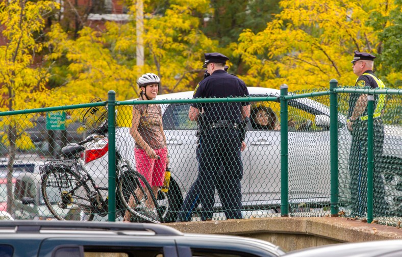 A cyclist talks with a police officer after she was involved in a traffic incident on Mystic Street. September 21, 2013.
