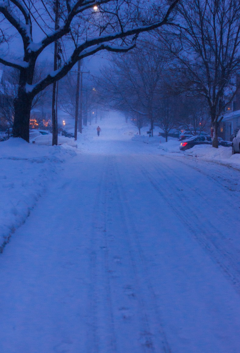 The snow doesn't prevent man from having his evening run down Dickson Avenue. December 17, 2013.