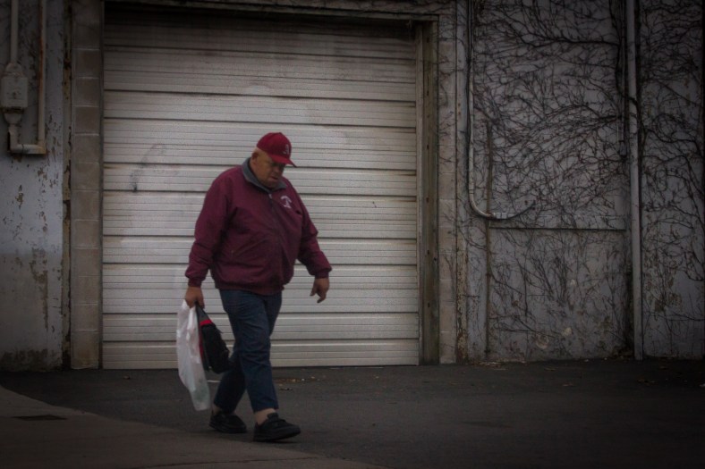 "Happy," who is known by many around town due to his work for the Recreation Department, walks down a deserted (due to an area-wide lockdown) Mill Street. April 19, 2013.