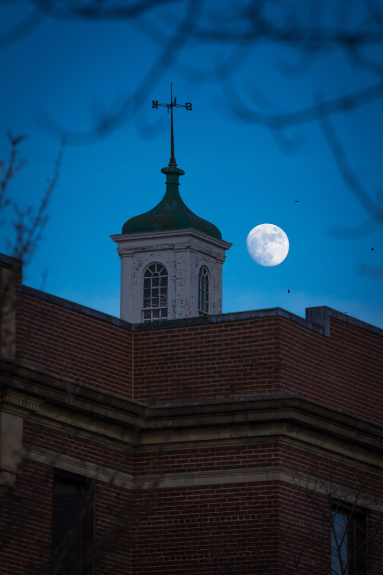 The moon rises over Arlington High School as it waxes toward a mid-month full moon. January 13, 2014.
