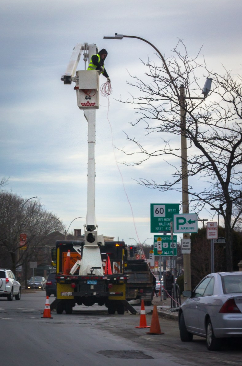 A man from the Department of Public Works takes down strings of holiday lights on the last day of January. January 31, 2014.