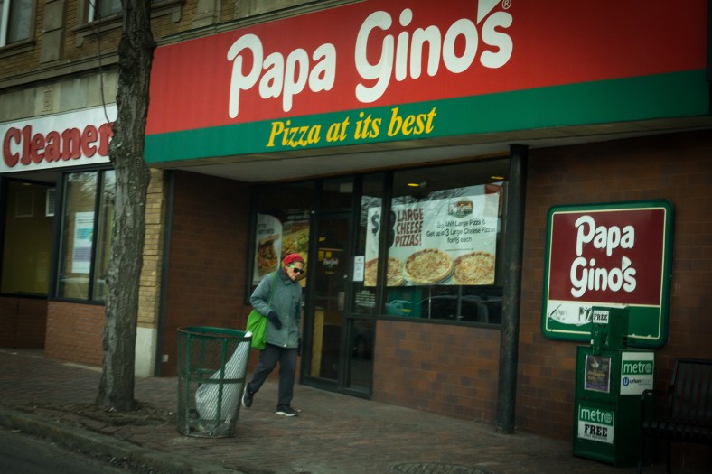 A woman walks by the Papa Gino's restaurant in Arlington center. January 31, 2014.