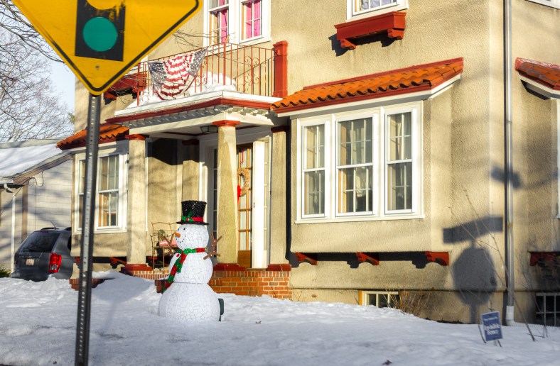 A snowman in the front yard of a Pleasant Street home worries not about the above freezing temperatures and direct sunlight. February 22, 2014. SC