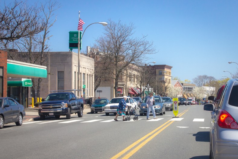 Two women make their way across Massachusetts Avenue in front of Town Hall. April 26, 2013.