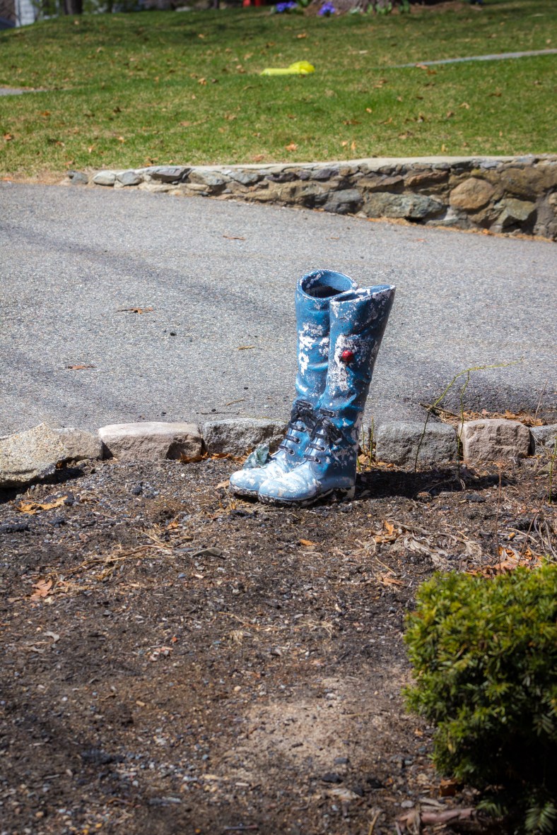 Decorative ceramic boots in the garden of a Winchester Road home. April 12, 2014.