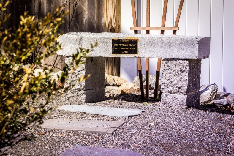 A small bench in a small landscaped area next to a small speed bump on Morningside Drive dedicated to Brian "Muzz" Murray. April 12, 2014.