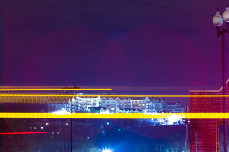 The lights of Arlington 360 shine bright as a 77 bus passes by on Massachusetts Avenue. May 2, 2014.