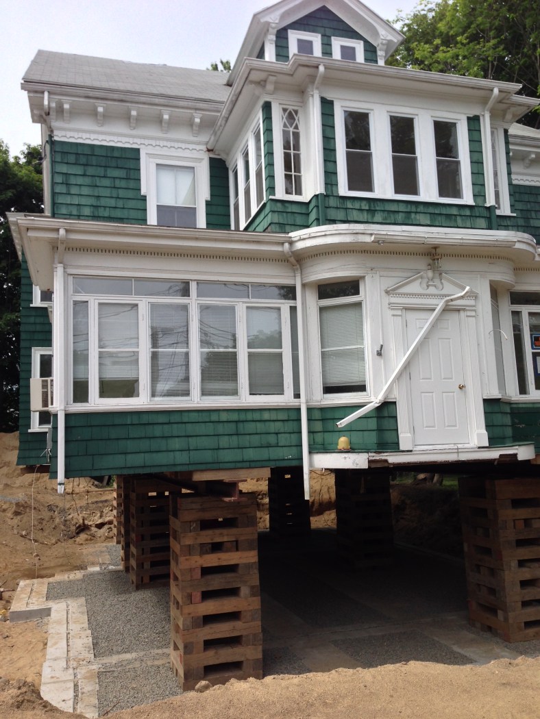 A house on Lake Street lifted for foundation replacement. June 11, 2014.