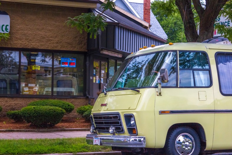 A 70s era GMC motorhome parked on Massachusetts Avenue outside of Mass Convenience. August 01, 2014.