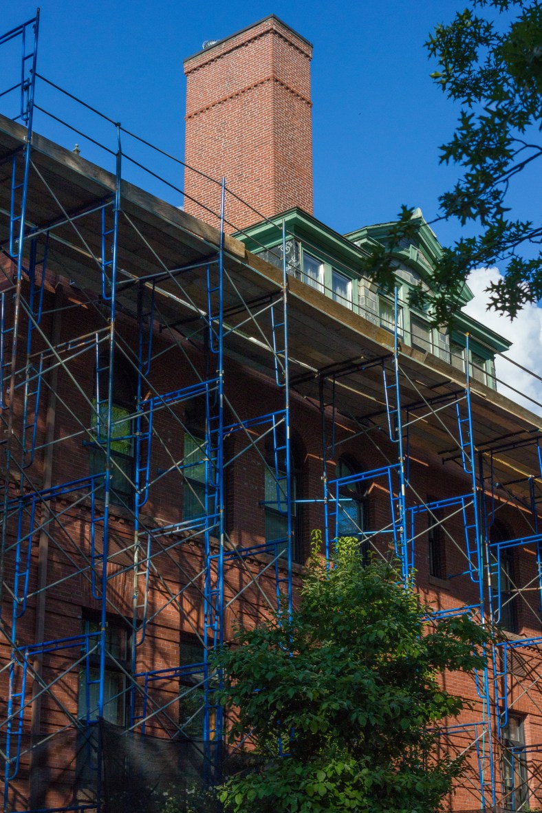 Scaffolding surrounds the The Locke apartments (formerly the Locke School,) as viewed from Paul Revere Road. August 8, 2014.