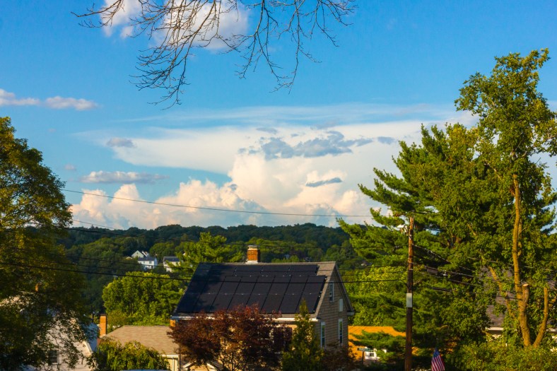 A view of Arlington Heights and the clouds beyond over the solar paneled roof of a Farmer Road home. August 8, 2014.