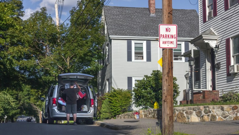 A man packs a van while parked at the crest of a hazardous blind hill on Brattle Street. August 8, 2014.