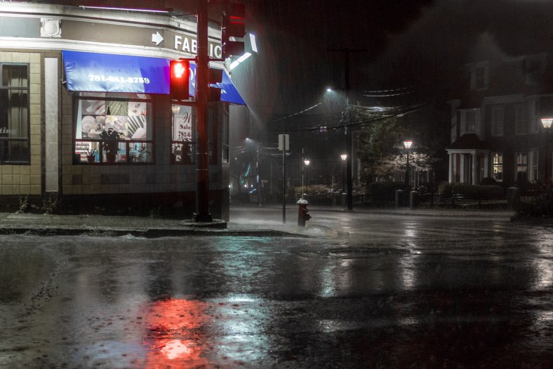 A heavy rain falls on a deserted corner of Massachusetts Avenue late on a Sunday night. August 31, 2014.