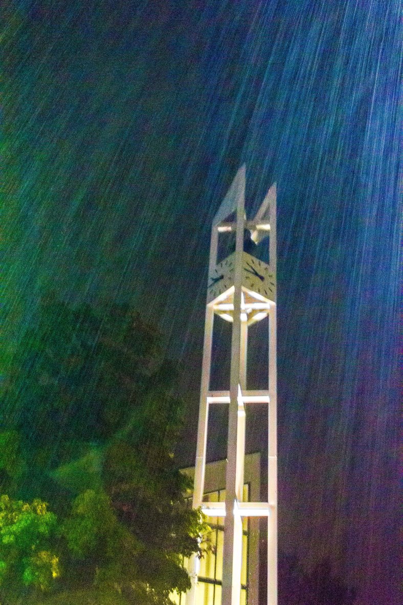 The clock tower of the Unitarian Universalist Church in Arlington Center in the heavy rain of a summer night. August 31, 2014.