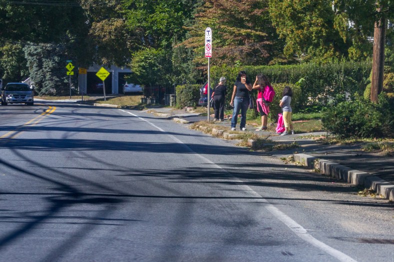 People wait for the 67 bus along Summer Street. September 26, 2014.