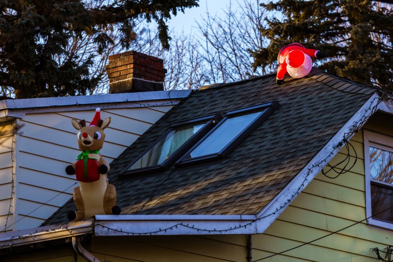 Possibly rushing due to lateness caused Santa to trip on the roof of a Washington Street home. December 26, 2014.