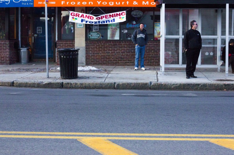 People wait at a bus stop in front of Frozland near Arlington High School. March 21, 2014.