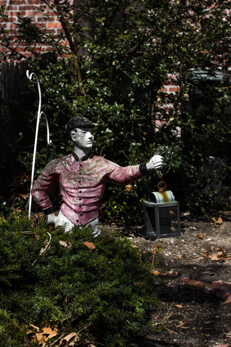 A yard ornament holds high a lantern on Winchester Road. April 12, 2014.