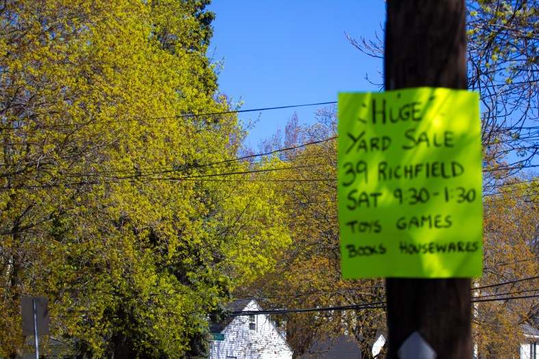 A sign (that nearly matches the budding leaves) advertising a yard sale on Summer Street. May 02, 2015.