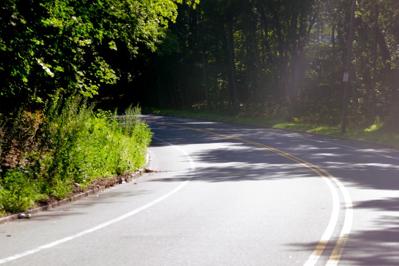 Sunlight and darkness at a bend of the Mystic Valley Parkway along the Lower Mystic Lake. August 05, 2015.