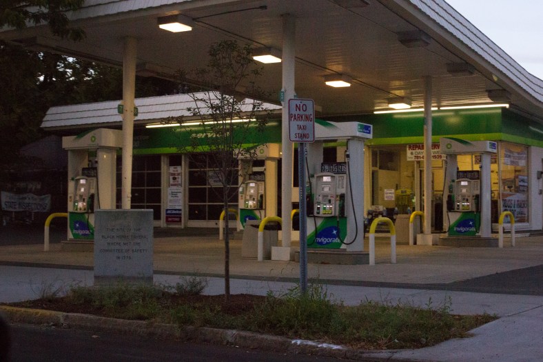 A historical marker, once set parallel to the street, reinstalled at a friendlier angle for passing drivers. September 26, 2015.