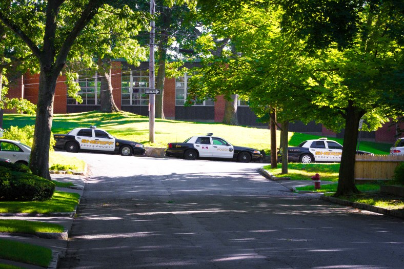 police cruisers from all over Eastern Massachusetts line Pleasant Street during a canine training exercise at Stratton Elementary School. April 26, 2014.